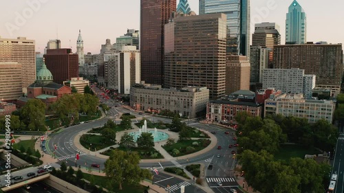 Vehilce traffic circles around the fountain at Logan Square in the bustling urban core of Philadelphia PA
