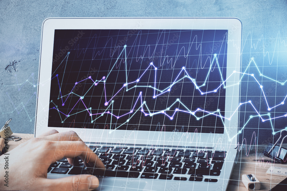 Forex graph with businessman working on laptop on background. Concept of hardworking. Multi exposure.