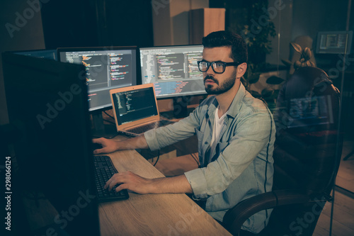 Photo of serious man employed to work as a system administrator solving client problems connected with their access to using programs attempting to renown grant it to them again