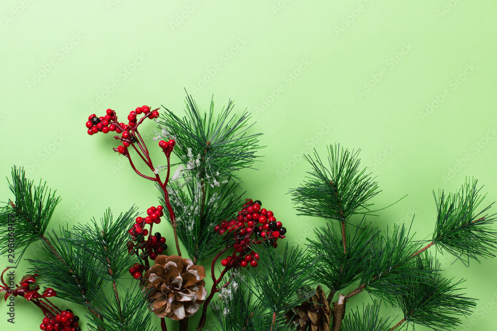 Fototapeta premium New Year background with christmas decorations on green.