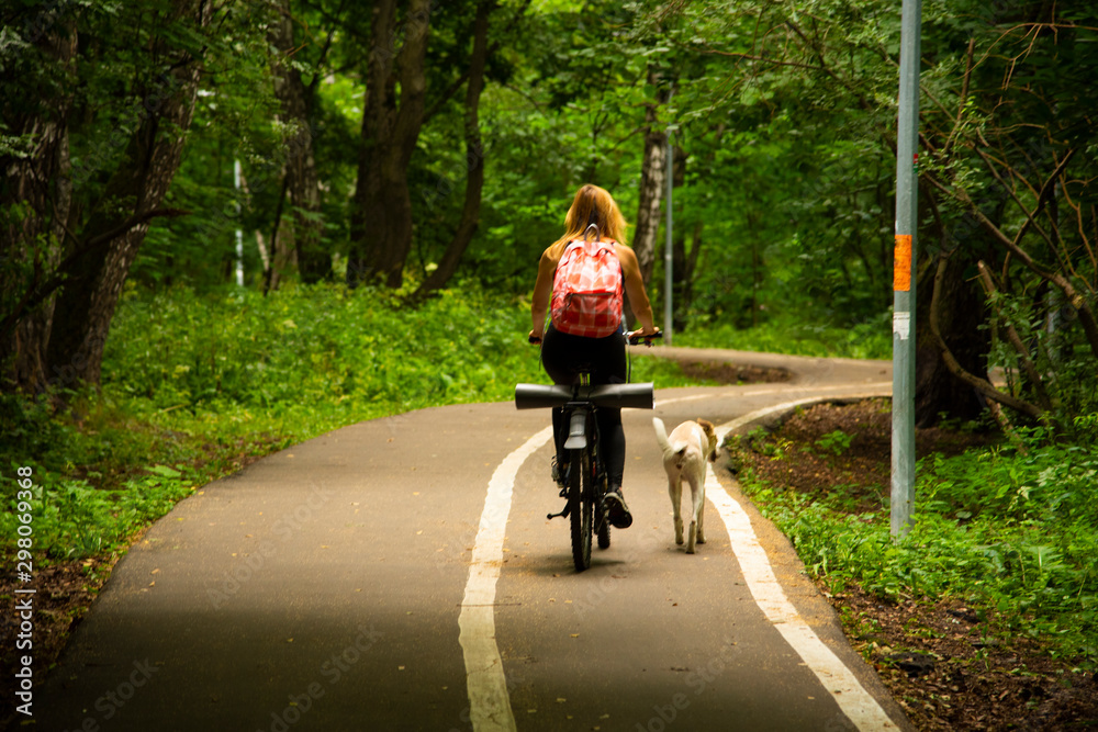 Sporty blonde in the Park on a bike