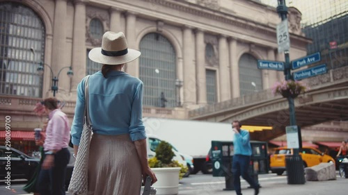 Young woman with a retro camera at the Grand Central Terminal 
