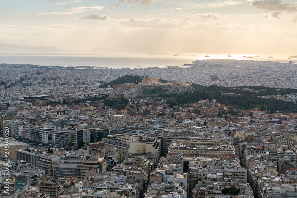 Sunset landscapes in Athens with ancient Acropolis and old city