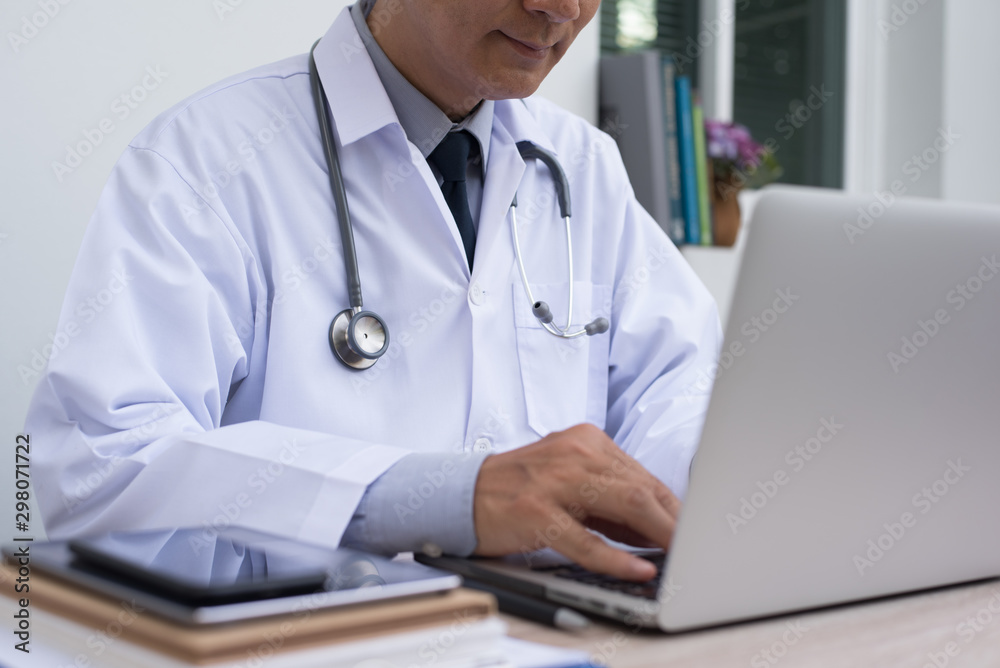 Doctor working on laptop computer Doctor working on laptop computer