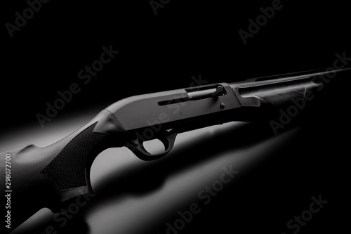 Modern semi-automatic shotgun on black background. Modern weapons on a dark background. photo