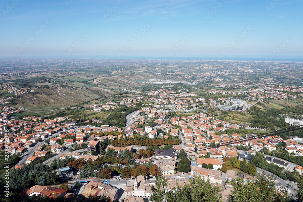 Republic of San Marino. Top view to the suburbs and the Rimini city and Adriatic sea in a distance