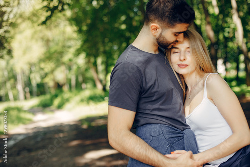 Couple in a forest. Beautiful blonde with her boyfriend