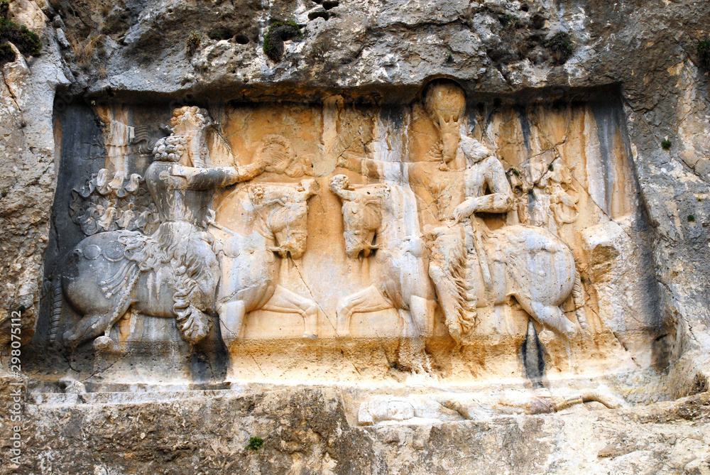 Bas-relief of ancien persian king Shapur I commemorating his victory over Romans. Bishapur ancient city area. Iran. Bas-relief of ancien persian king Shapur I commemorating his victory over Romans. Bishapur ancient city area. Iran.
