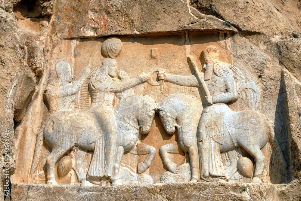Sassanian stone reliefs in Naqsh-e Rostam (rock tombs of ancient iranian kings Darius III, Artaxerxes I, Darius I and Xerxes I). Iran.