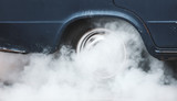 Smoke from under the wheels of a car