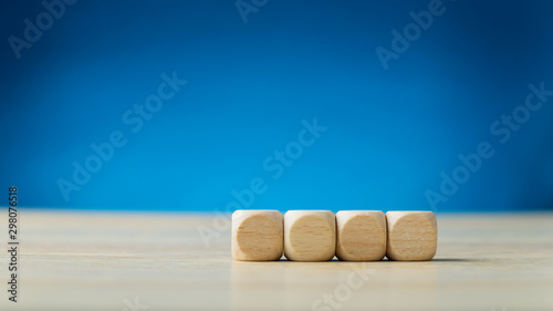 Schilderij op canvas Four blank wooden dices placed in a row