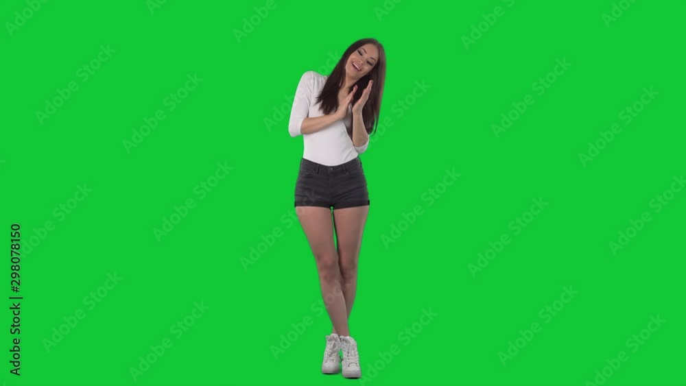 Cheerful excited young beautiful woman clapping hands applauding and celebrating. Full body isolated on green screen chroma key background Cheerful excited young beautiful woman clapping hands applauding and celebrating. Full body isolated on green screen chroma key background
