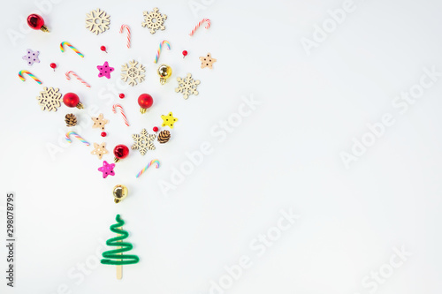 Christmas background concept.Top view of christmas tree splash out christmas decoration with gift box  candy cane  snowflake  star and colorful ball on white background with copy space for text.