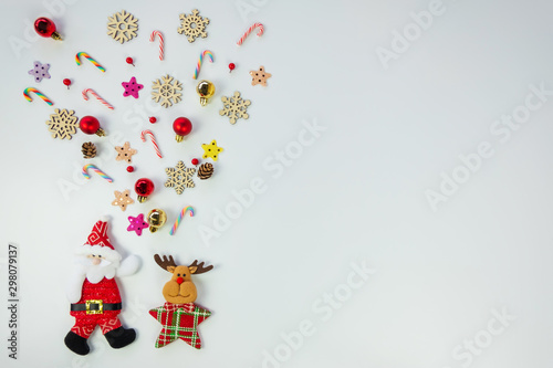 Christmas background concept.Top view of santa claus and reindeer splash out christmas decoration with candy cane, snowflake, star and colorful ball on white background with copy space for text. © pongsakrit