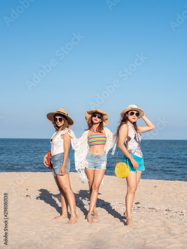 Group of women wearing hat enjoying on the beach, lifestyle concept