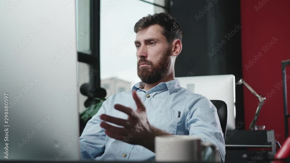 Man executive typing keyboard working on computer in the office. Portrait of baffled business guy having internet troble or non-working computer.