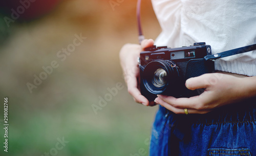 Hand and camera of the photographer Holding and carrying the camera to take pictures