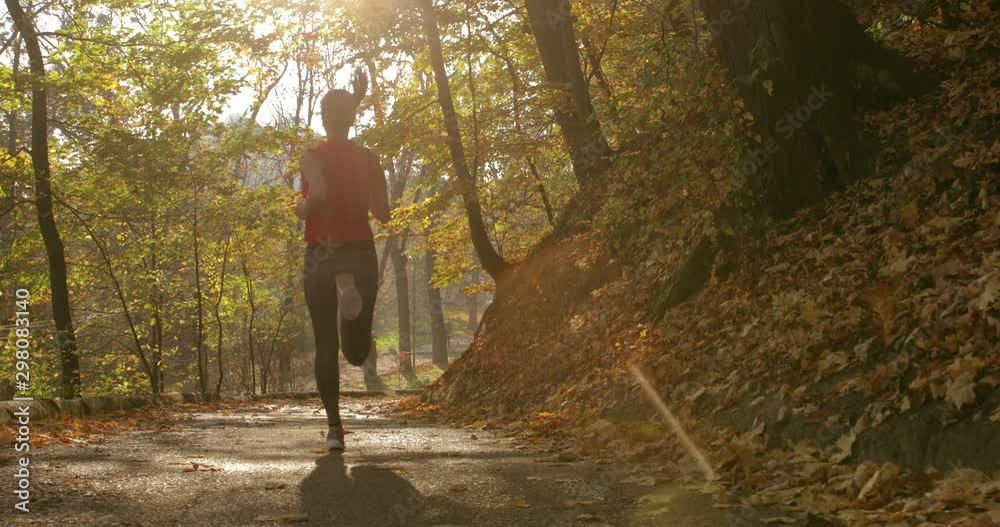 girl makes a run on the road. training. jogging. master shot. back view