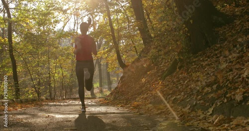 girl makes a run on the road. training. jogging. master shot. back view