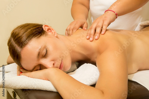 Oil back massage, a woman in the spa having aromatherapy massage with essential oil 
