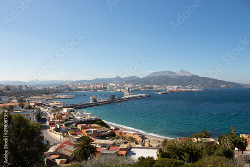 View of the sea and sea port from the top of a hill on a sunny summer day