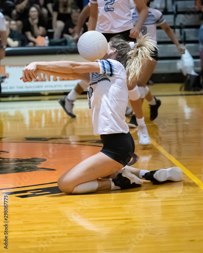 Girl volleyball player saving the ball during a volleyball game