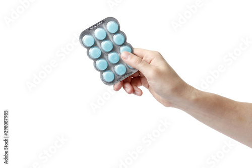 hand man holding color pills in blister pack on white background, close up