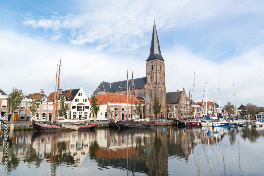 Church and boats in south harbour canal of Harlingen, Netherlands
