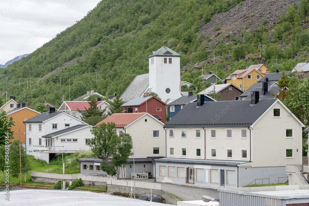 church and houses of little village in northern fjord at Oksfjord, Norway