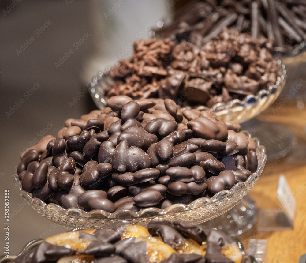 Fototapeta premium Chocolate almonds in decorative glass bowl