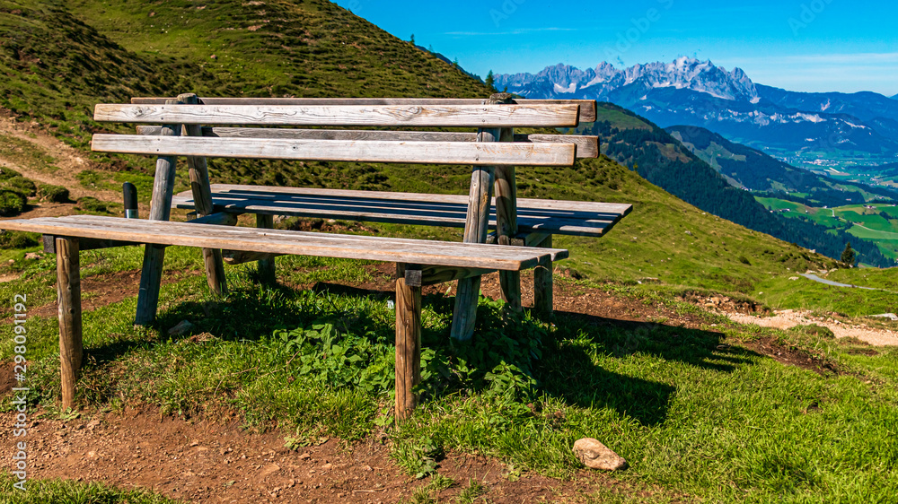 Beautiful alpine view with a wooden bench at Fieberbrunn, Tyrol, Austria Beautiful alpine view with a wooden bench at Fieberbrunn, Tyrol, Austria