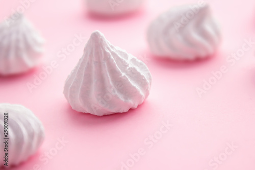 White meringue cookies on pink pastel background