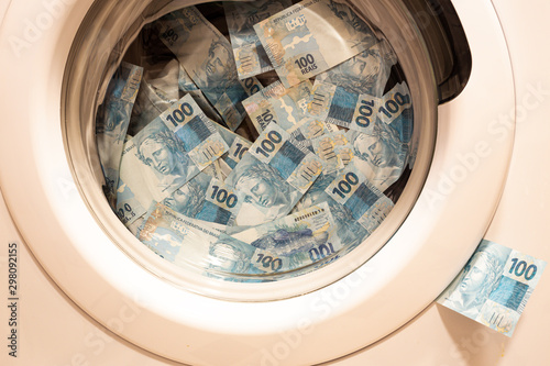 Quadro su tela Brazilian money in the washing machine, the concept of money laundering