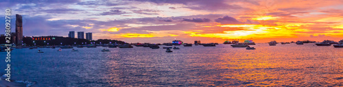 Panorama view of travel destination Pattaya Beach and PATTAYA lighting alphabet logo on sunset. photo