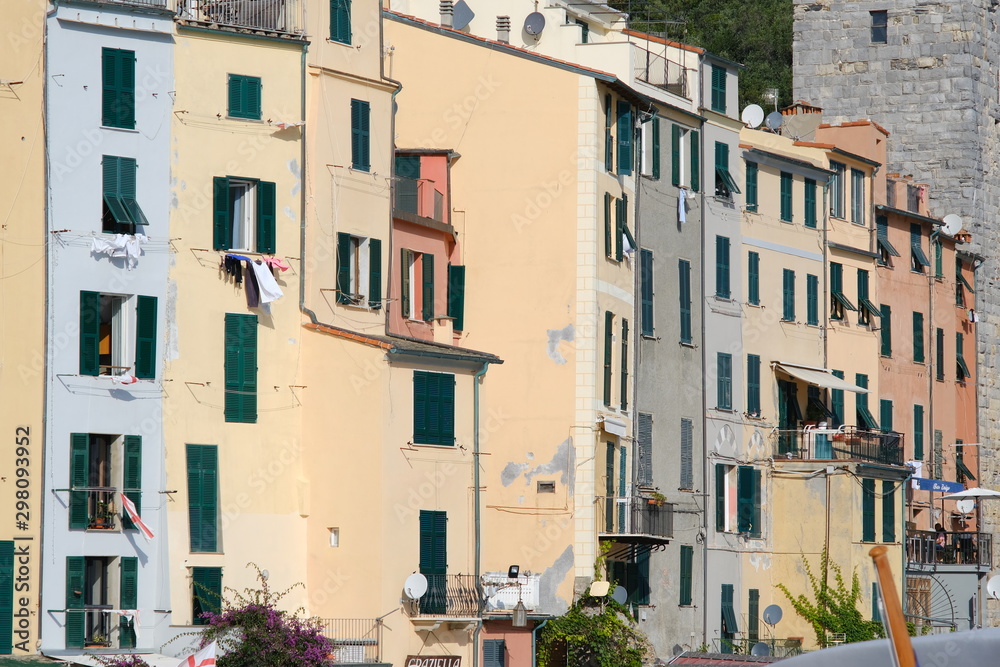 Typical Ligurian houses in the village of Portovenere. In the background a tower belonging to the walls of the fort.