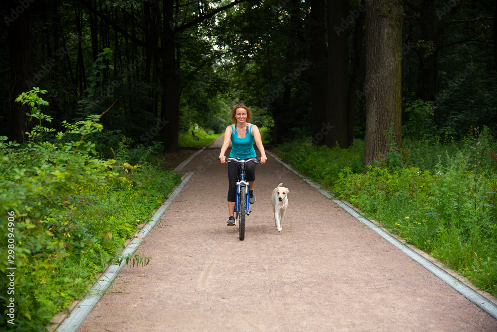 Girl on a bike ride with a dog