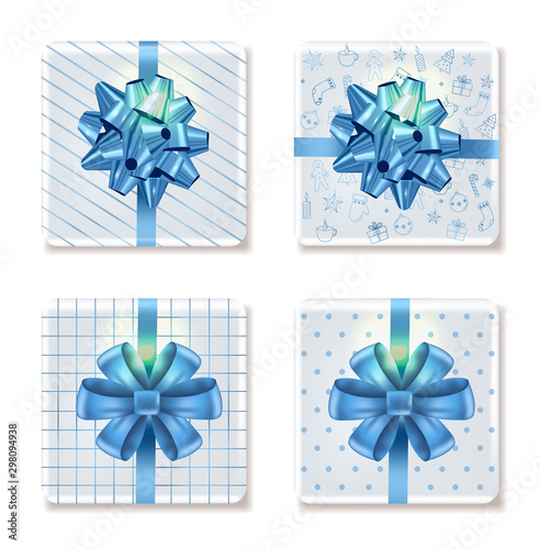 Top view on christmas white gift boxes with different ornaments. Blue ribbon....