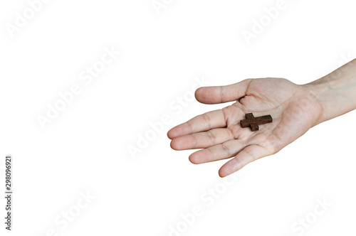 Mini wooden crucifix on people hand isolated on white background, wooden cross on hand religion concept.