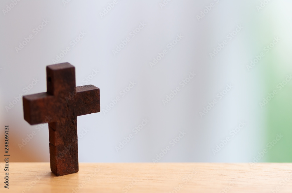 Mini wooden crosses the symbol for the god of Chris with copy space and blur background.