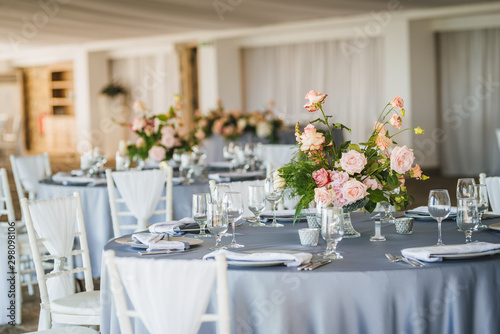 Luxury wedding table decoration. Special event table set up. Fresh flower decoration. Pastel colors - blue and pink decoration © miladrumeva