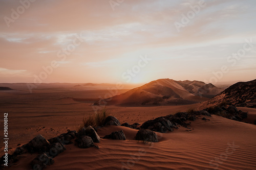 Cloudy sundown sky over hills and rocks in arid desert in evening in Morocco © Manuel Orts/ADDICTIVE STOCK