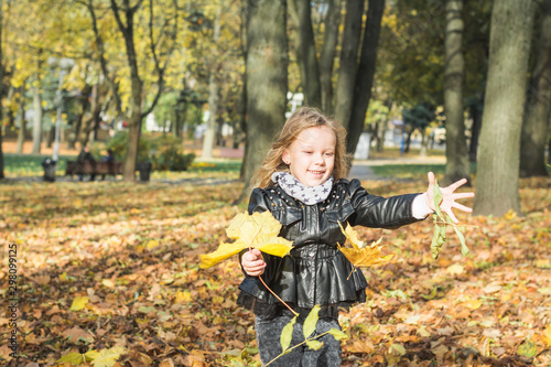 happy little child, baby girl laughing and playing in the autumn © bisonov