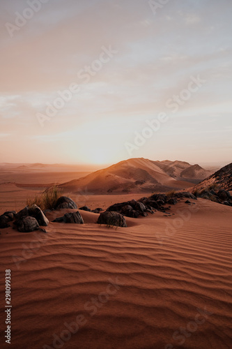 Cloudy sundown sky over hills and rocks in arid desert in evening in Morocco