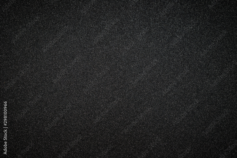 Metallic glitter black background, close up. Dark gray paper backround. Black glitter background from wrapping paper. 