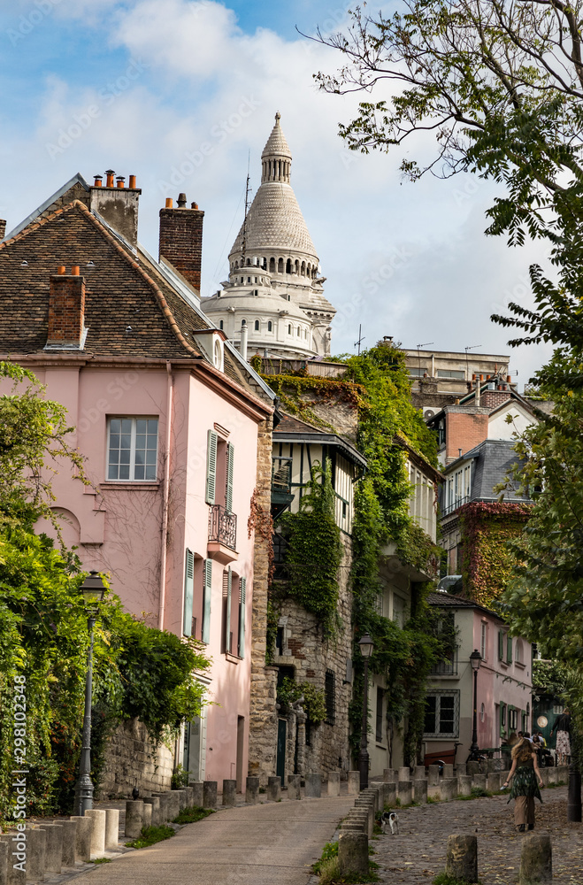 View of old cobblestone streets of Montmartre district in Paris, cozy narrow leafy street in Montmartre quarter of Paris, France. Architecture and landmarks of Paris.