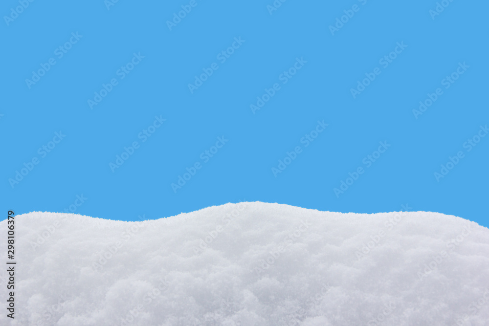 snowdrift isolated on blue background close-up