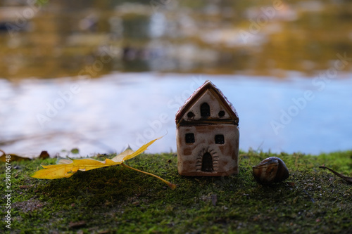 House and leaf on background of lake. Real estate market