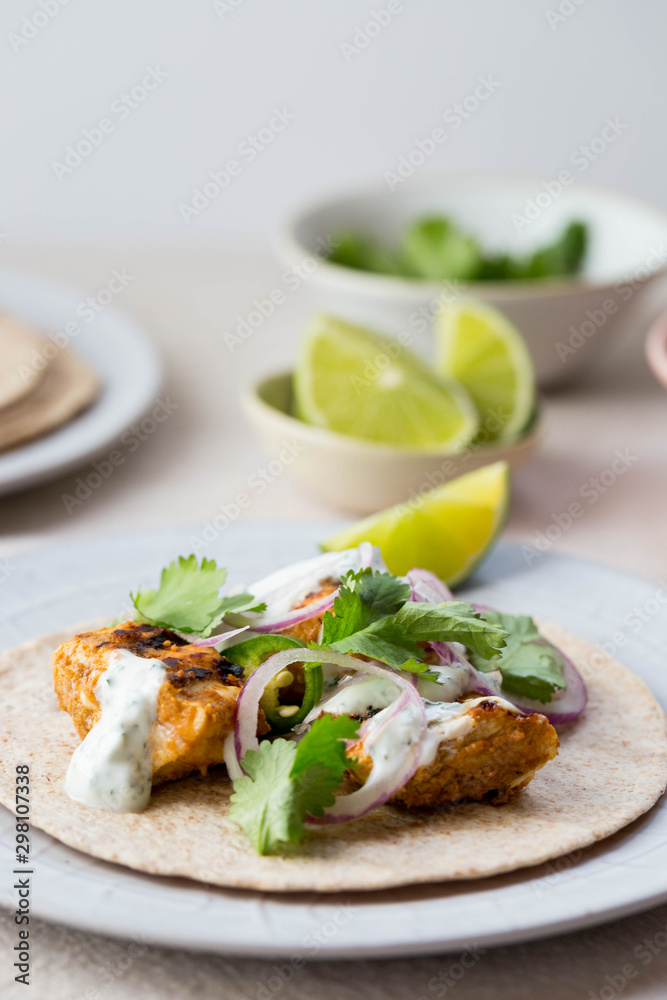 Chicken tikka wraps with Indian spices and condiments Chicken tikka wraps with Indian spices and condiments
