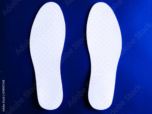 Inseat insole in white shoes On a blue background