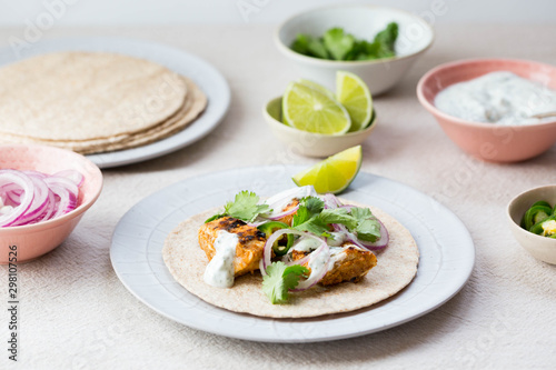 Chicken tikka wraps with Indian spices and condiments photo